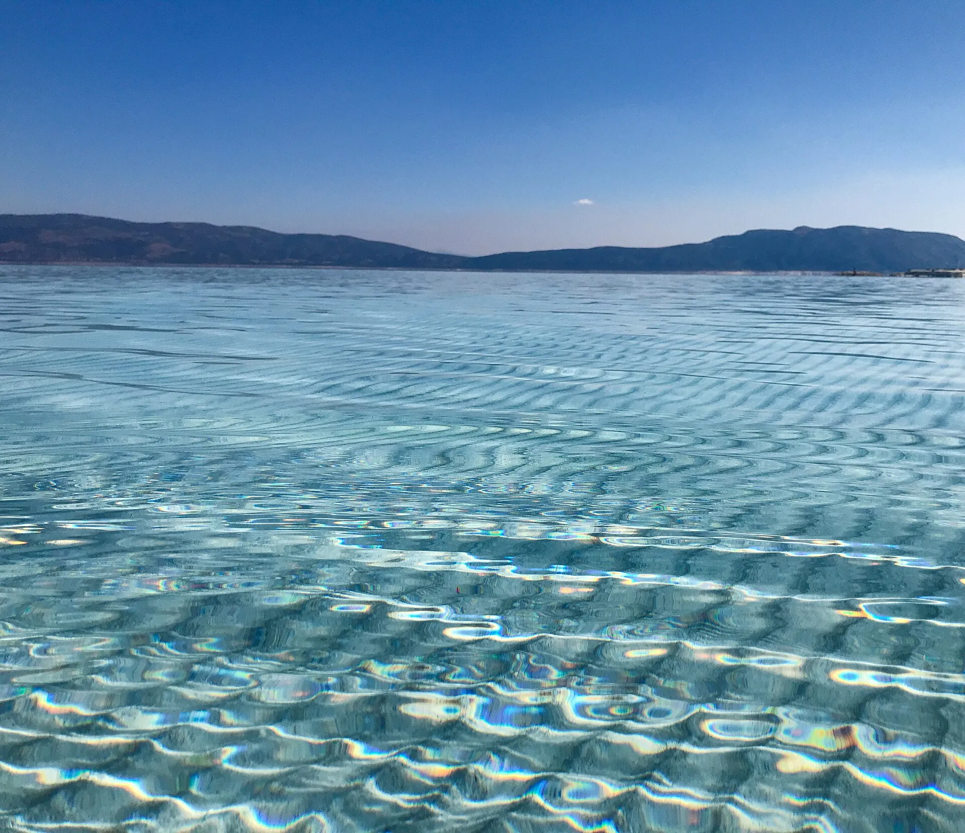 The bright white mineral shore of Salda Lake meeting turquoise water
