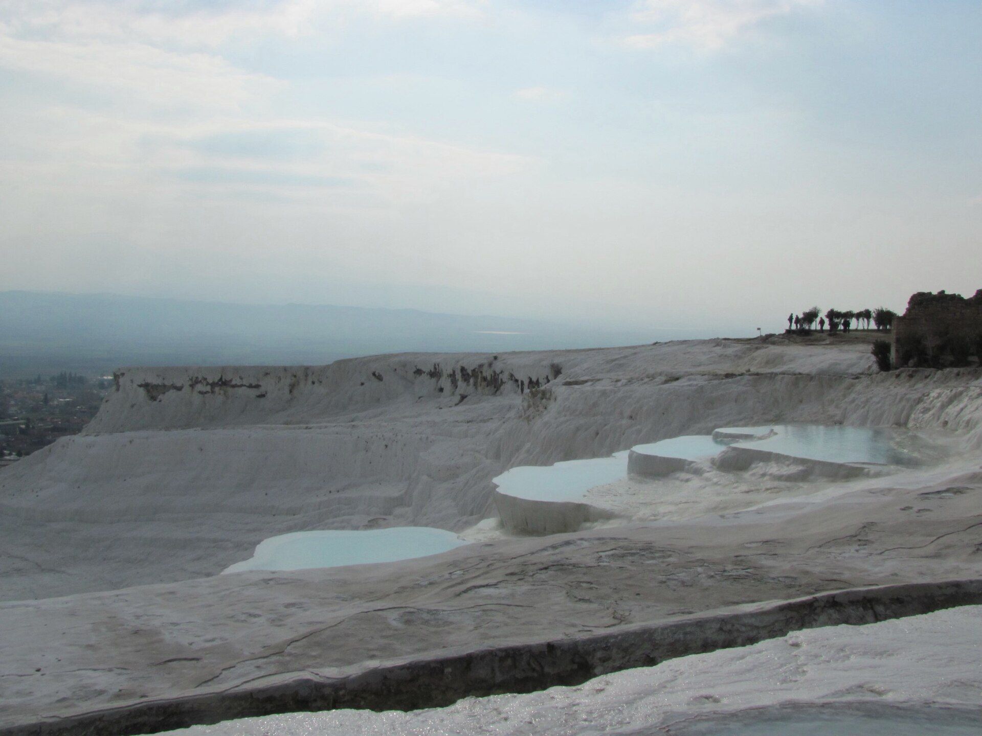 Mineral-white travertine terraces and turquoise pools at Pamukkale