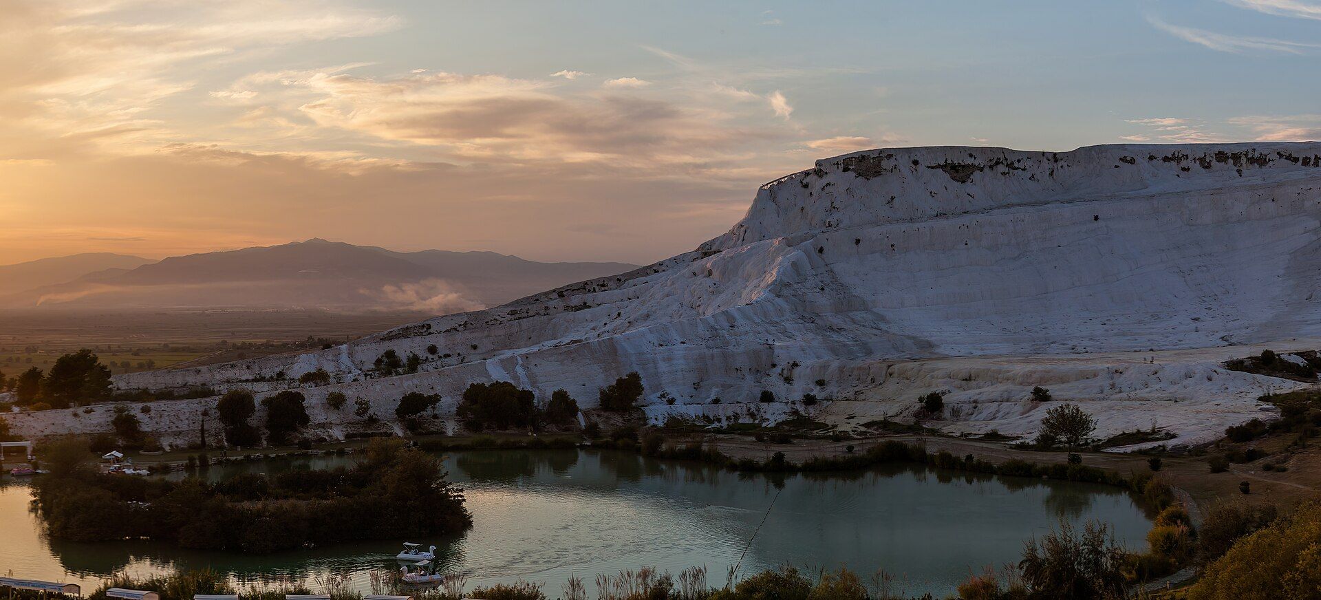 The white travertine terraces of Pamukkale glowing gold at sunset