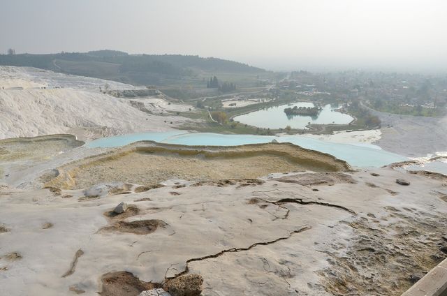 The white travertine terraces of Pamukkale with water-filled and dry sections on the same slope