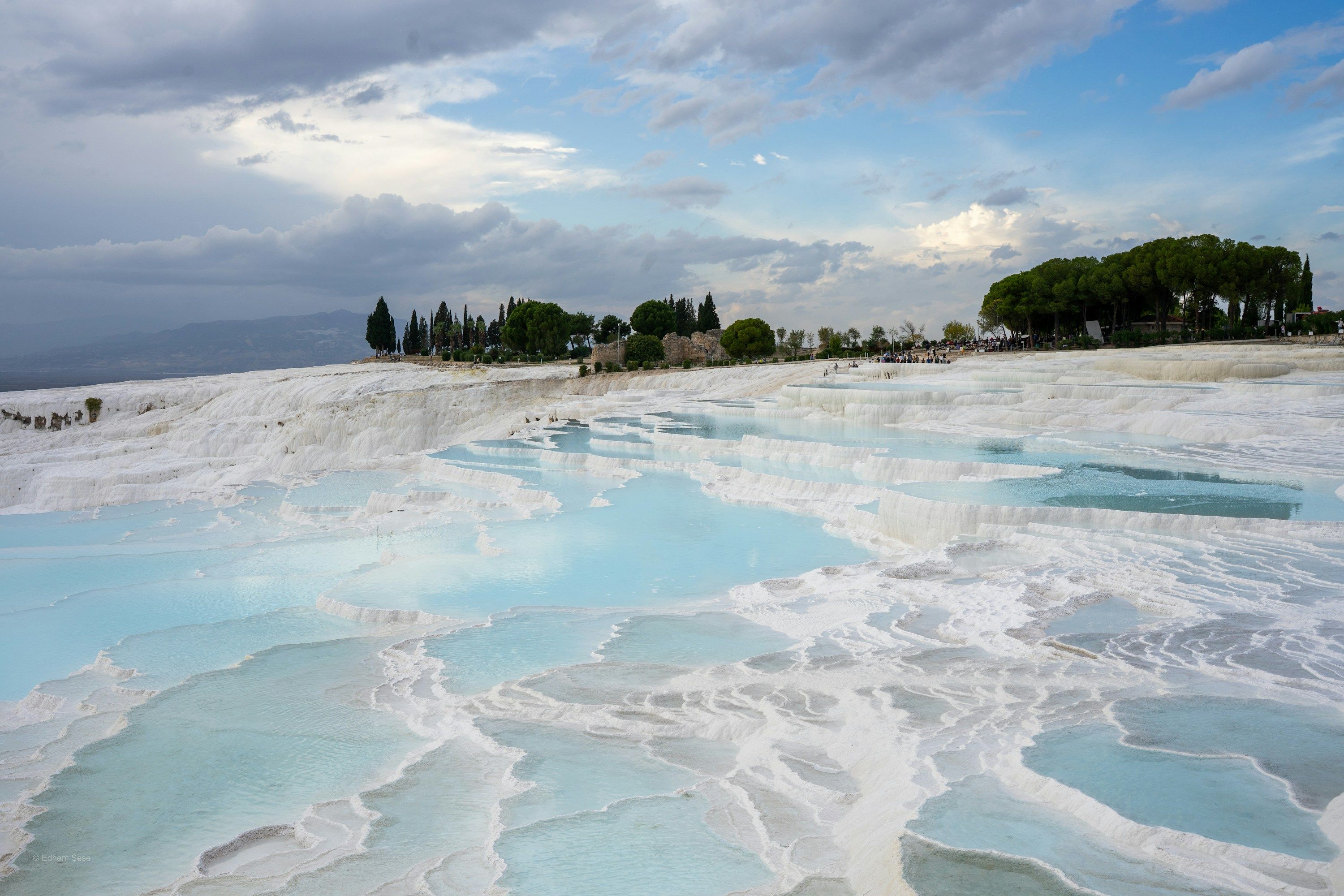 The white travertine terraces and turquoise thermal pools of Pamukkale