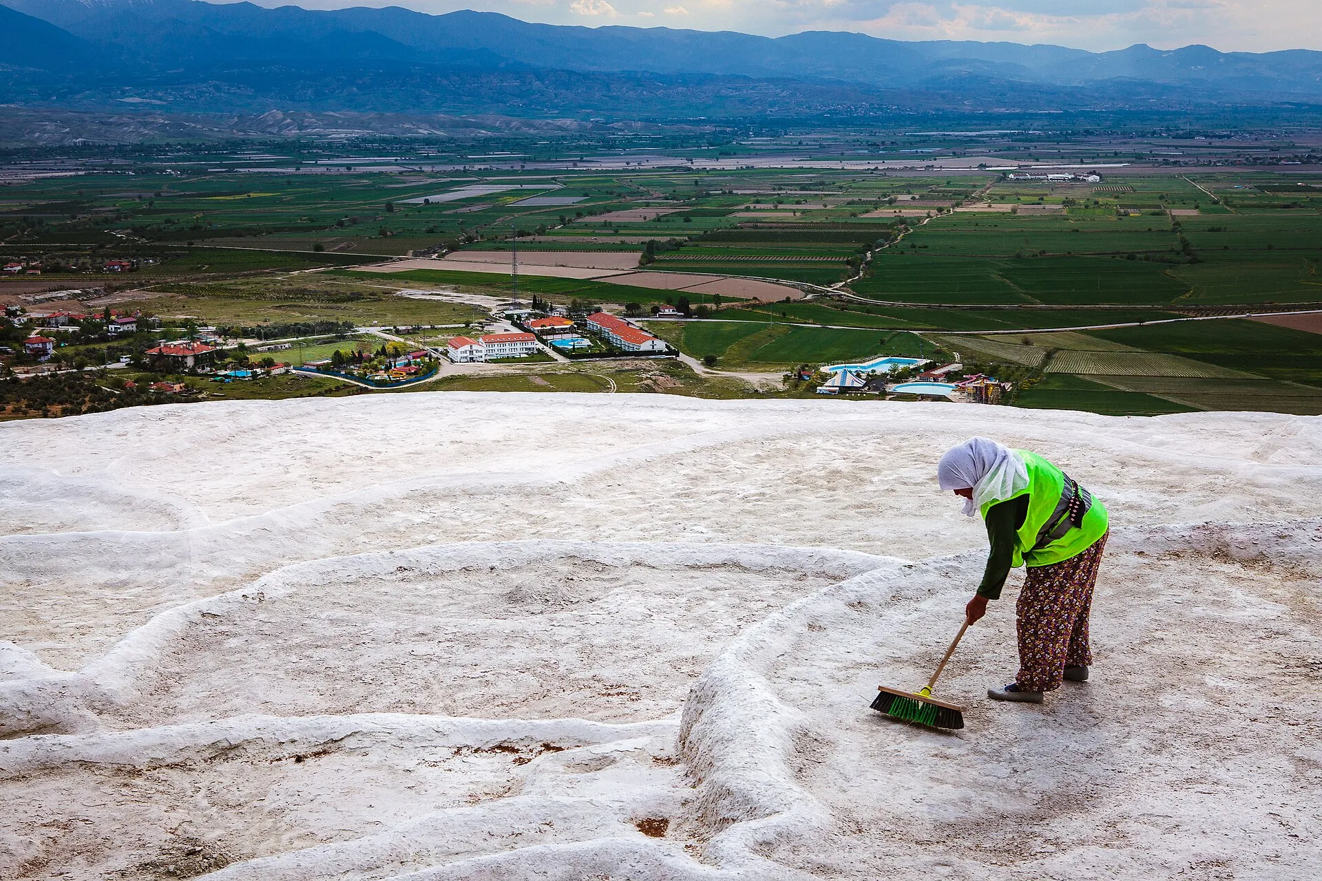Visitor walking barefoot up the Pamukkale travertine slope