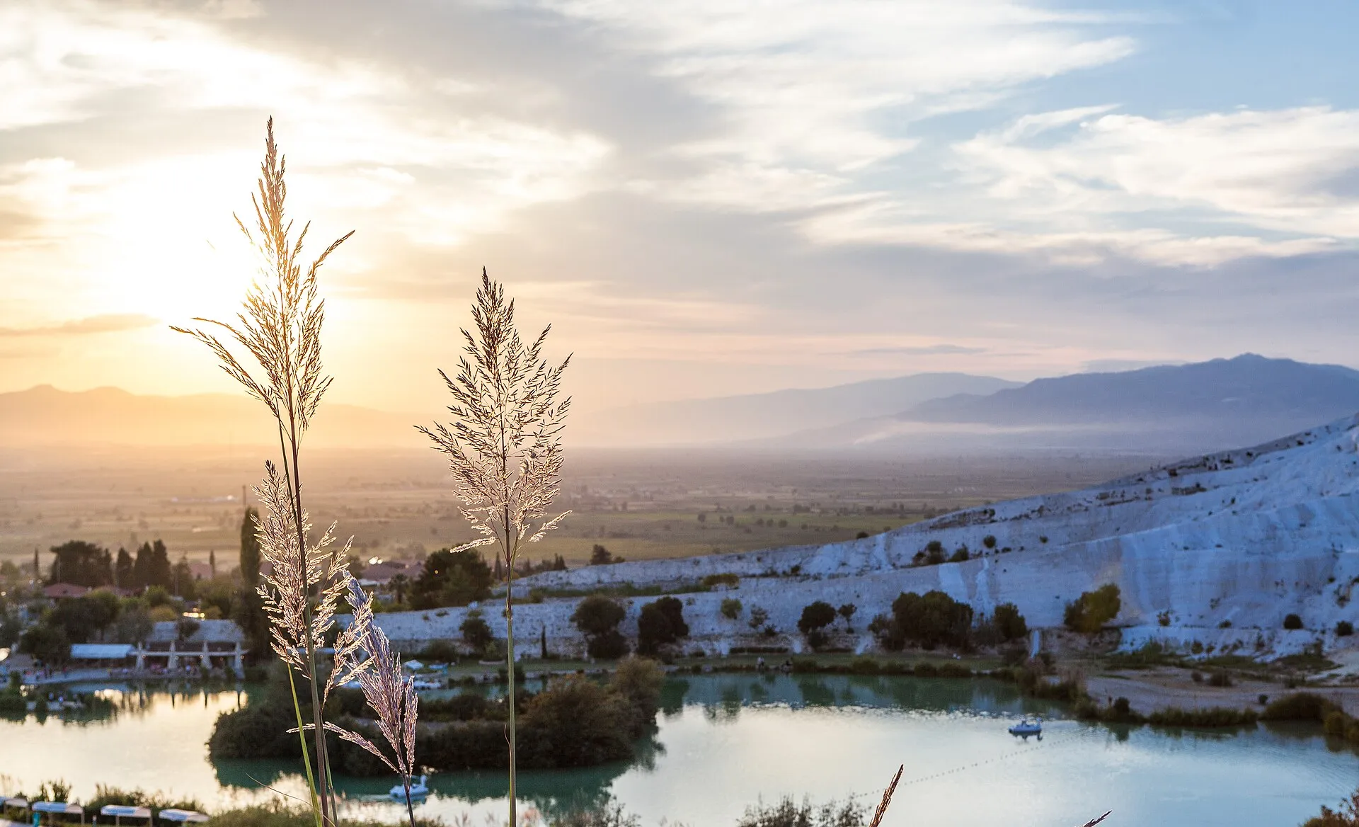 The classic view down the stacked travertine pools toward the valley at golden hour