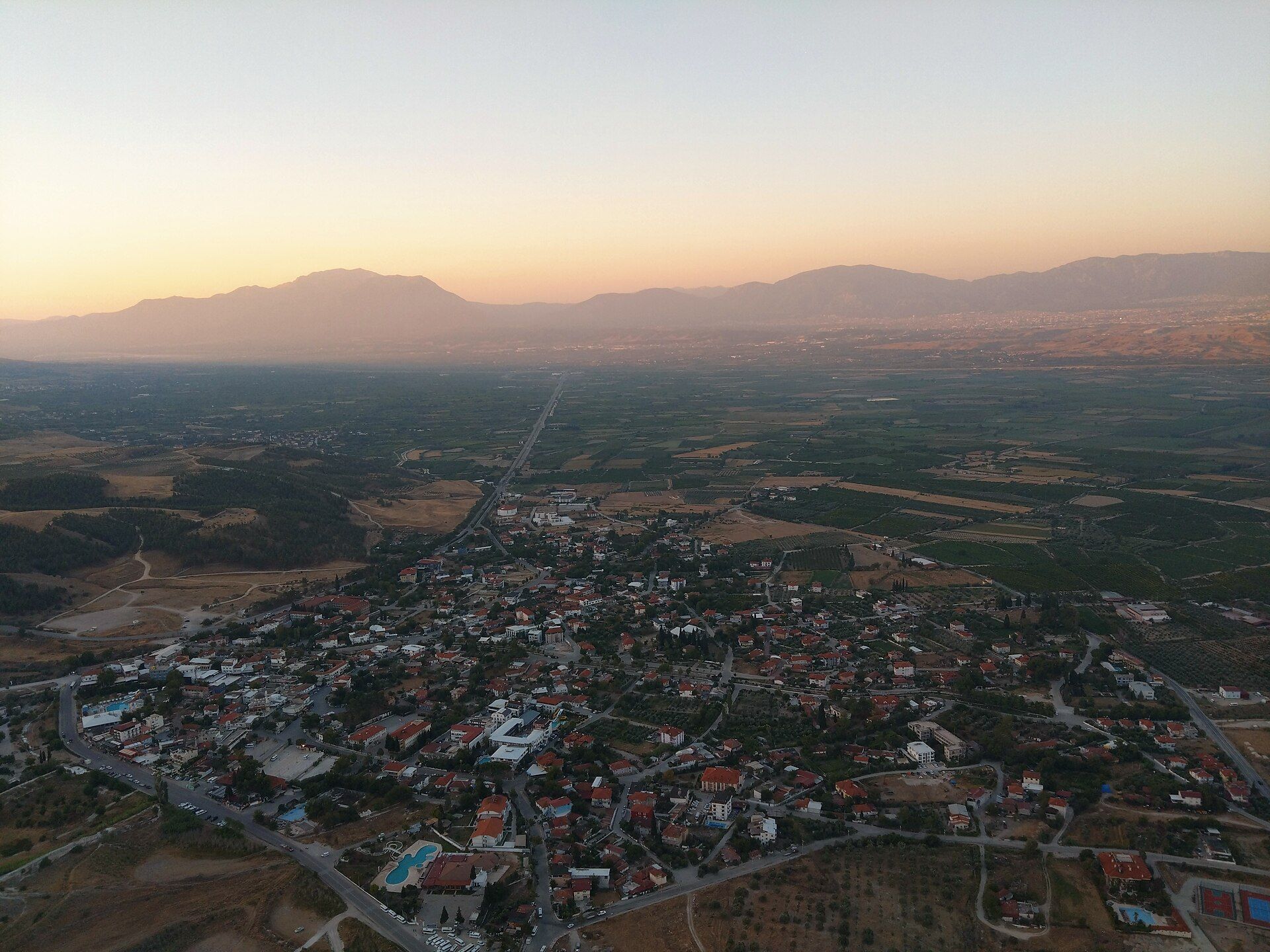 Aerial sunrise over the Pamukkale valley and village, seen from a hot-air balloon